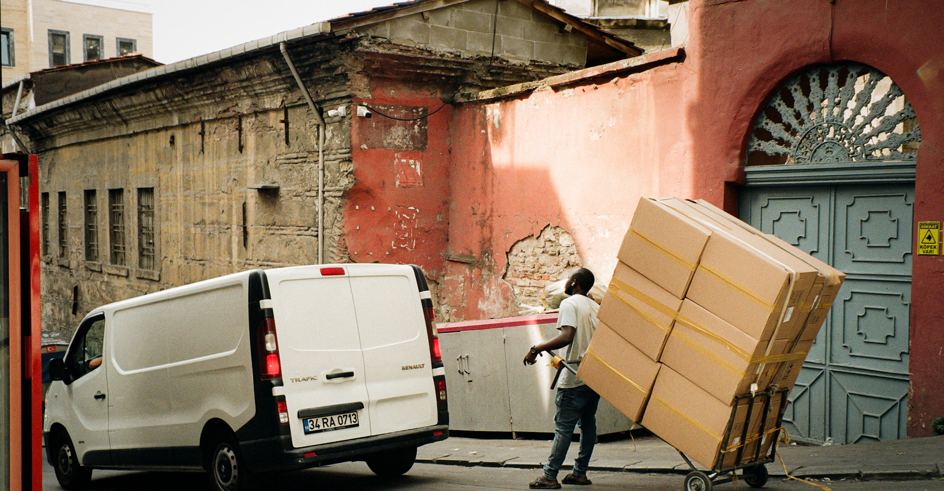 Furniture movers unloading items from a moving van outside a home