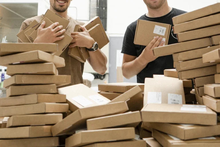 Movers packing cardboard boxes for a move