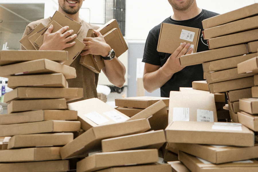Movers packing cardboard boxes for a move