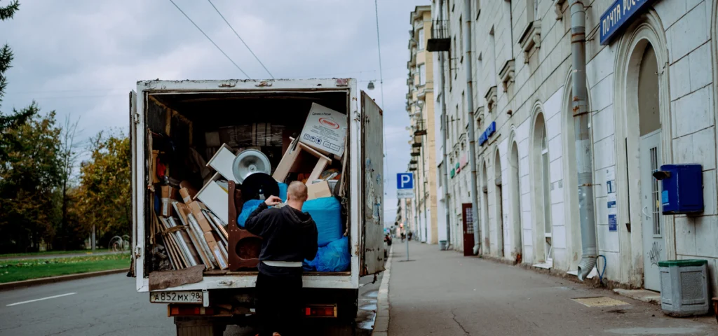 Mover unloading furniture from the back of a moving truck