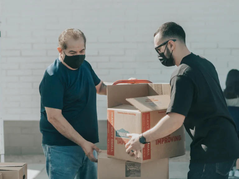 Movers handling boxes during a residential move