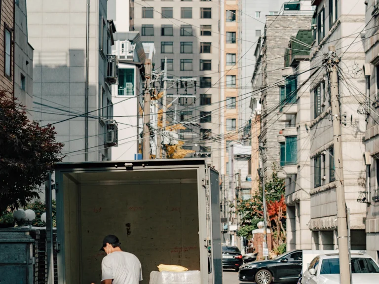 Mover unloading furniture from a moving truck with a dolly