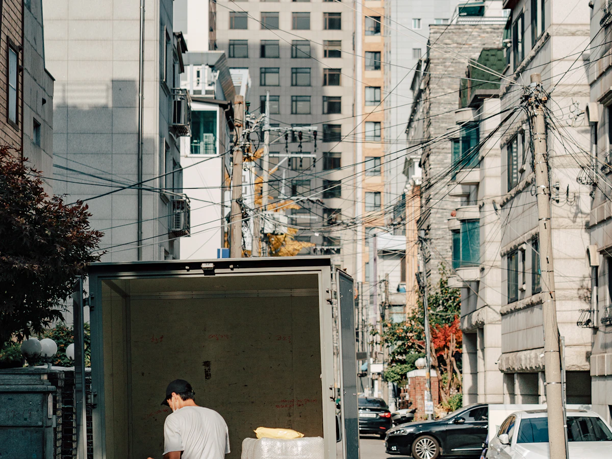 Mover unloading furniture from a moving truck with a dolly